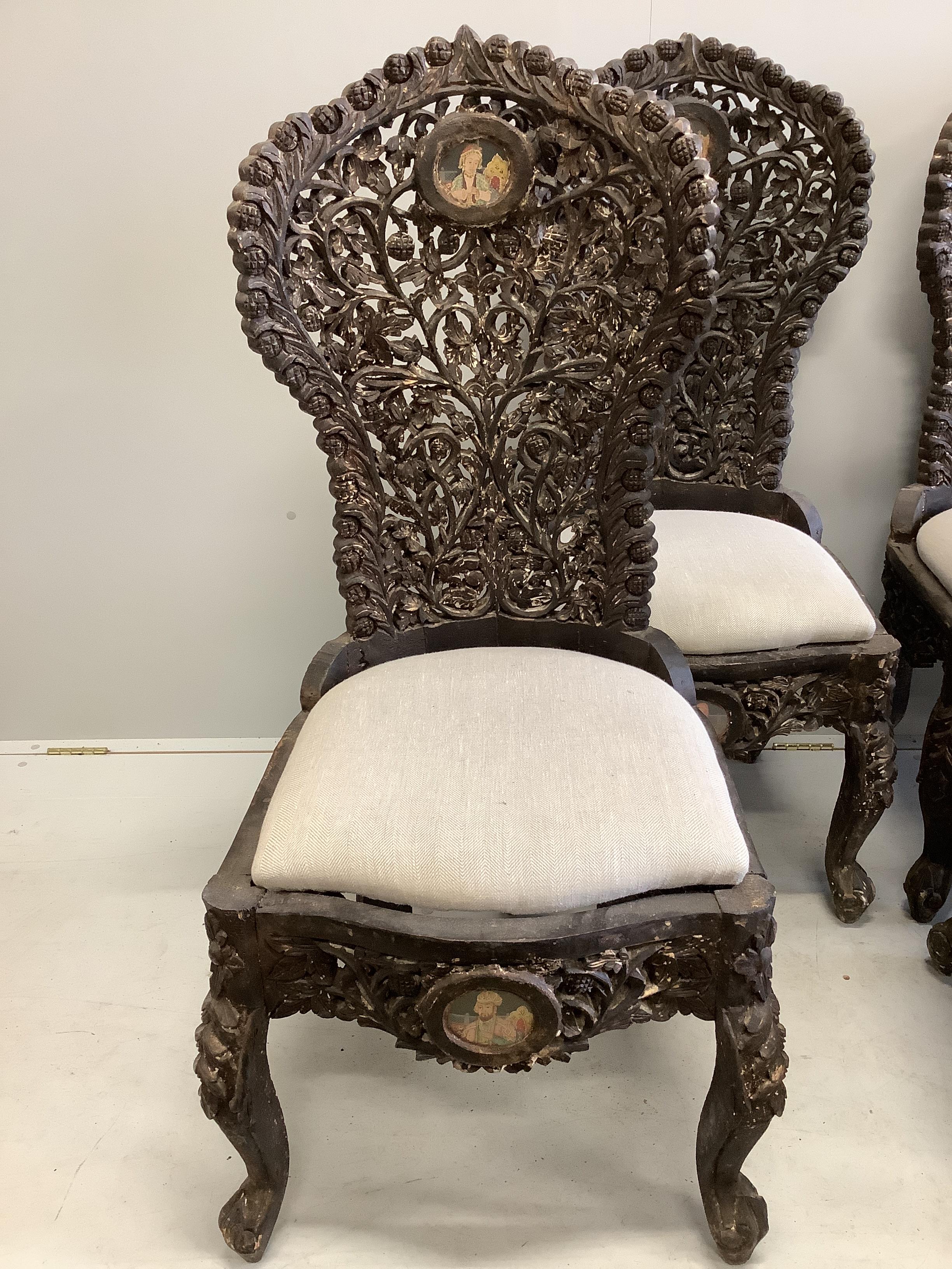 A set of six Indian carved hardwood chairs inset circular portrait plaques, width 48cm, depth 52cm, height 118cm